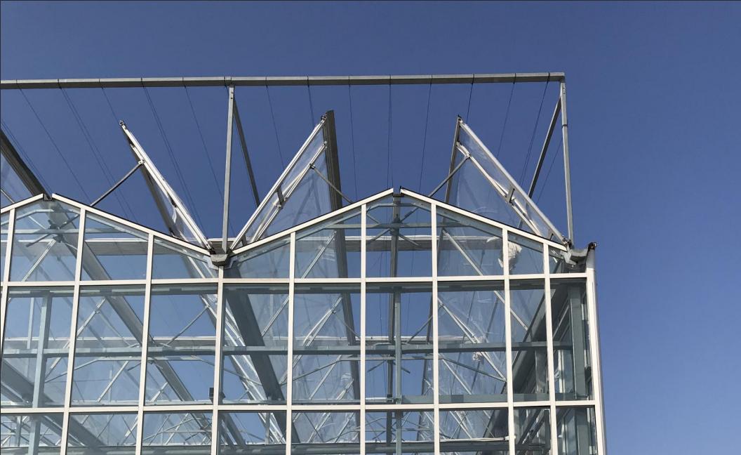 What are the Functions of a Smart Climate Control System in a Glass Greenhouse?